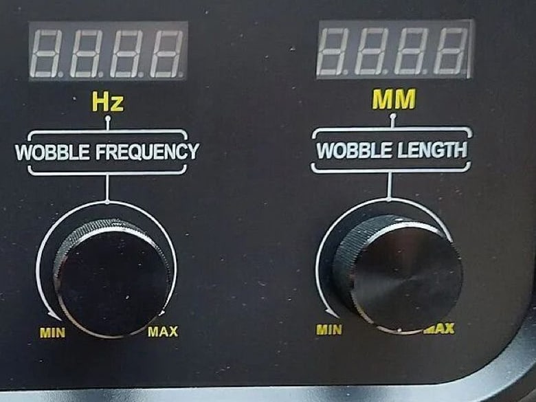 Wobble frequency and wobble length knobs on the control panel of the Ascent 2000W refrigeration laser welder, each under a digital display marked Hz and MM